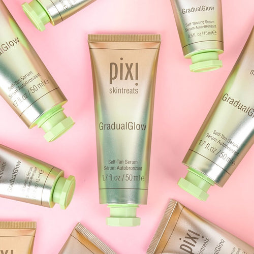 PIXI Gradual Glow skincare products on a pink background view 1