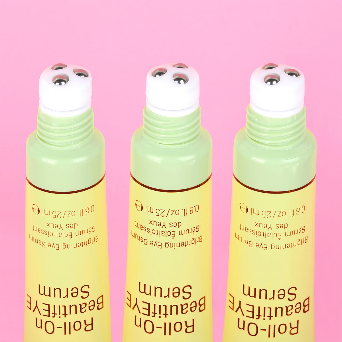 Three bottles of BeautifEYE Roll-On Serum on a pink background - close up of rollerball