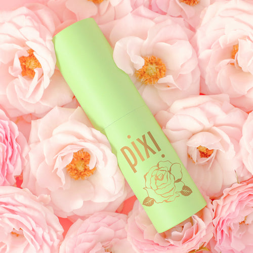 PixiRose Perfume shown on a rose background view 1